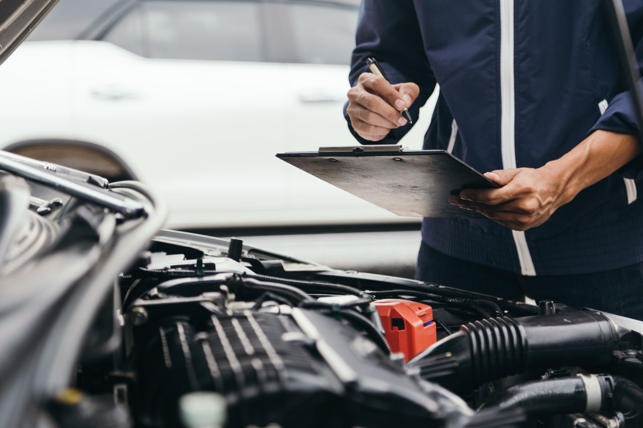 false Automobile mechanic repairman hands repairing a car engine automotive workshop with a wrench, car service and maintenance,Repair service.