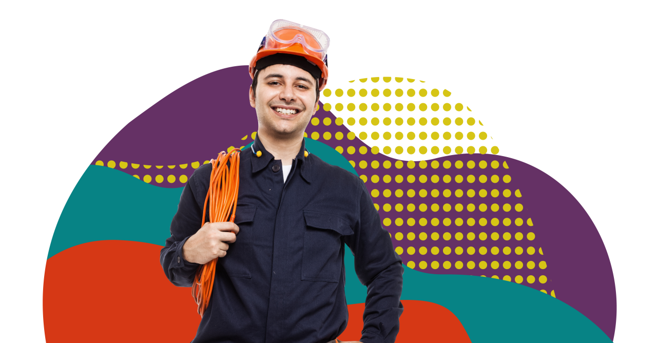 male contractor with hard hat safety googles and an extension cord wearing navy blue work shirt